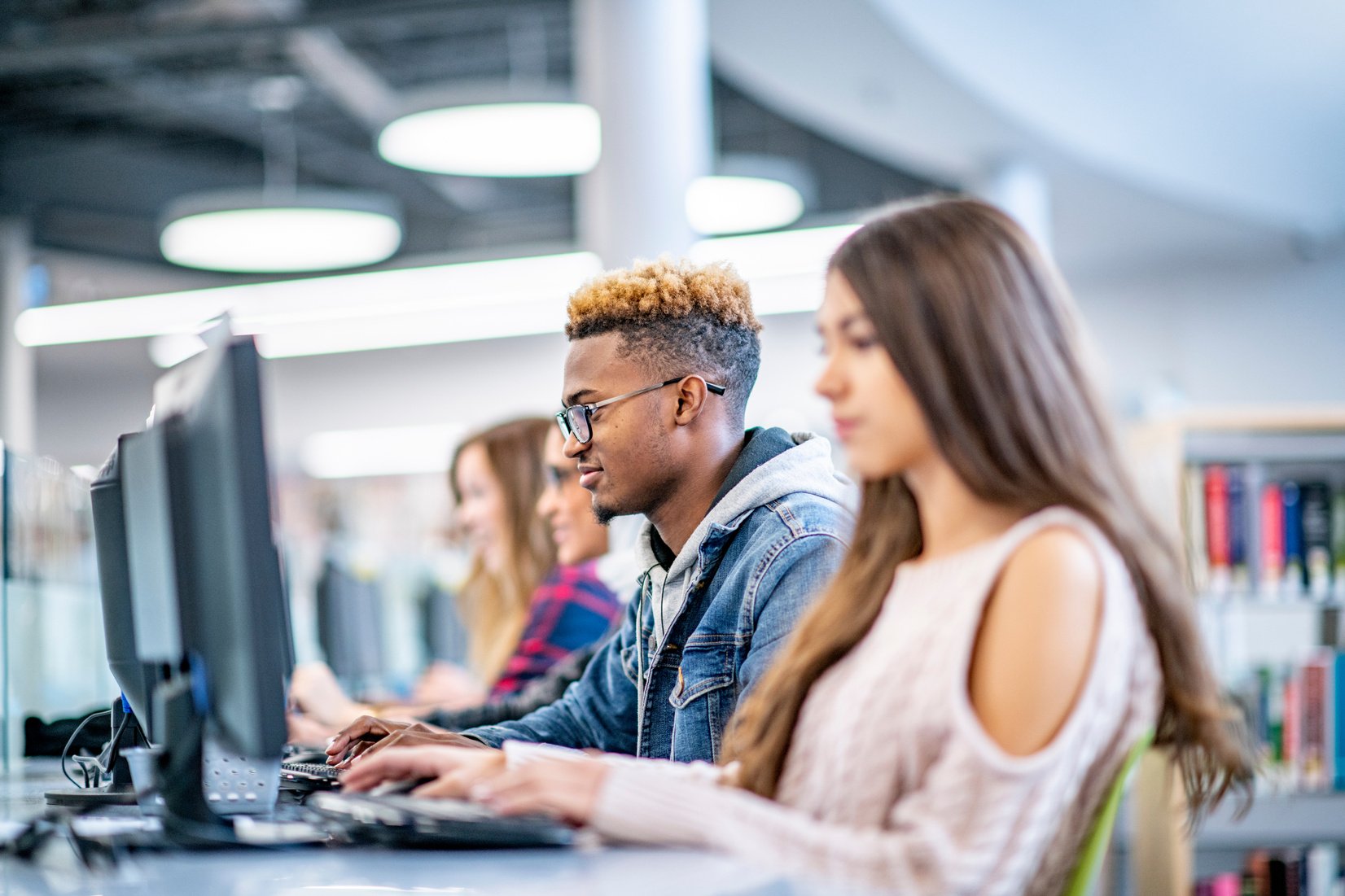 College students working on library computers